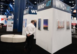 A visitor checks out Foto Relevance's booth at the Windpower 2019 Conference. The convention underwrote the Houston gallery's booth in order to showcase artists responding to wind energy. (Photo by Priscilla Dickson)