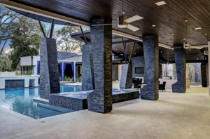 The pool and summer kitchen at 3 W. Rivercrest includes the requisite hot tub.