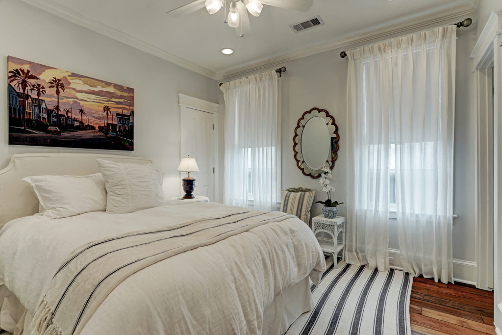 One of four guest bedrooms with en suite bath in the Beachtown home on Galveston Island.  (Photo by TK Images)