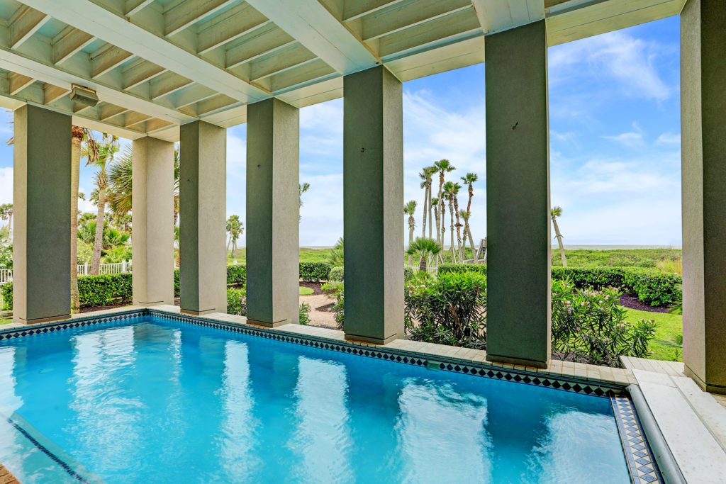 The loggia with swimming pool and view to the gulf is a special amenity at the Beachtown home.  (Photo by TK Images)