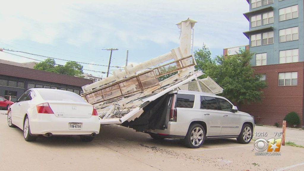 A billboard fell and crushed a car on McKinney Avenue in Uptown. (Photo by CBS DFW)