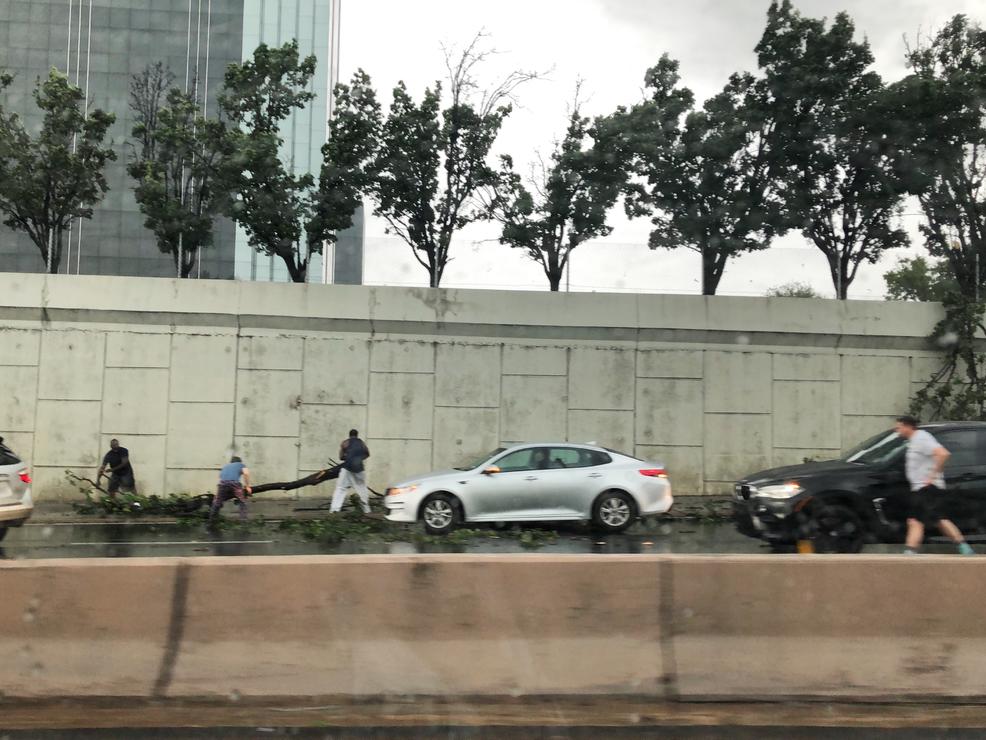 People starting to help clean up the damage on Dallas North Tollway. Photo by Lisa Van Akin