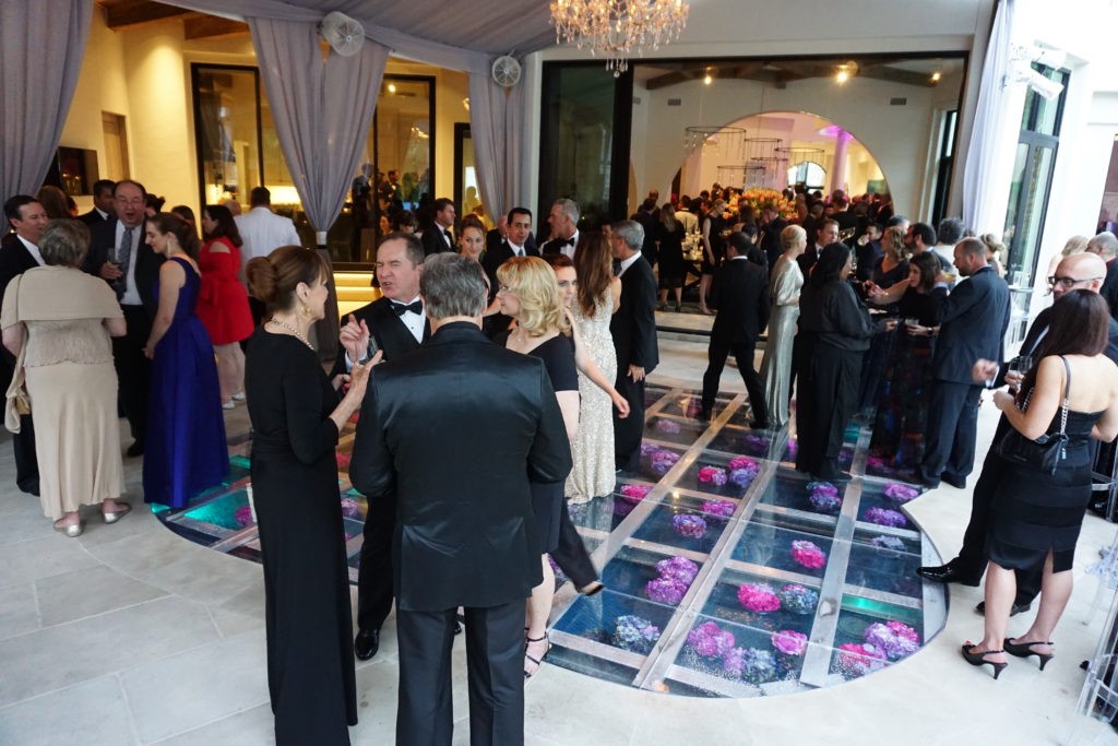 The see-through dance floor reveals fresh flowers floating just beneath the acrylic flooring at the Theorem Wine release party. (Photo by Al Torres Photography)