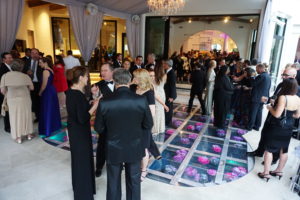 The see-through dance floor reveals fresh flowers floating just beneath the acrylic flooring at the Theorem Wine release party. (Photo by Al Torres Photography)