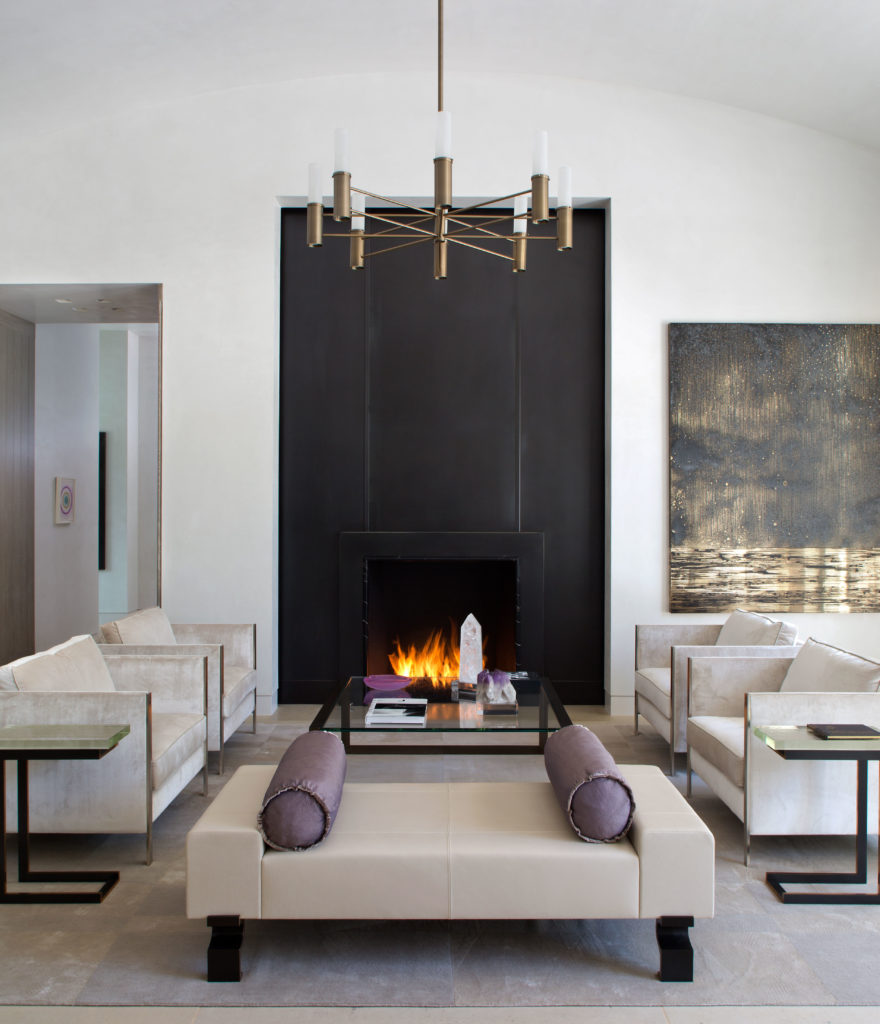 In the great room, Holly Hunt daybed. Evan Lewis cocktail table from George Cameron Nash. John Boone chandelier. Bronze fireplace inspired by Diego Giacometti. (Photo by Emily Minton Redfield)