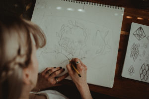Influenced by her background in graphic design, Lynn methodically sketches each design before she paints (Photo by Christina Childress)
