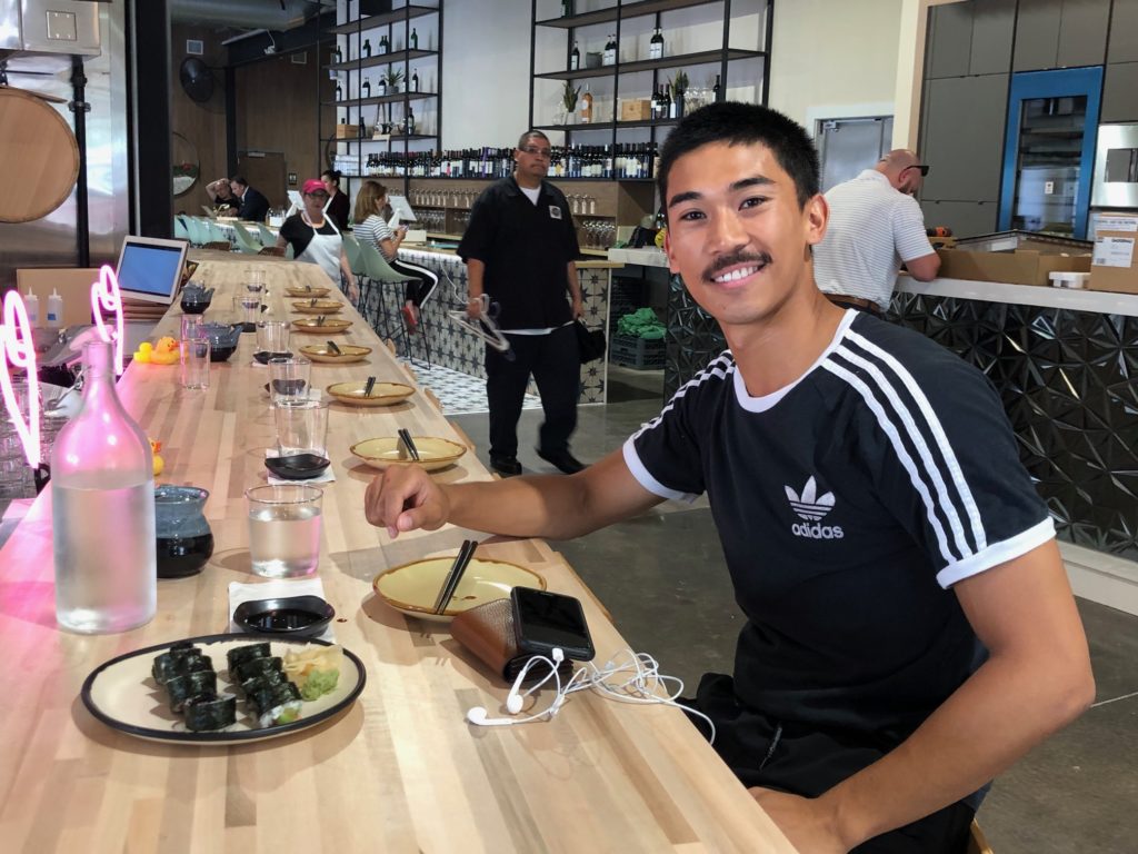 Houston Ballet corps member Syvert Lorenz Garcia samples the sushi at Kokoro. (Photo by Shelby Hodge)