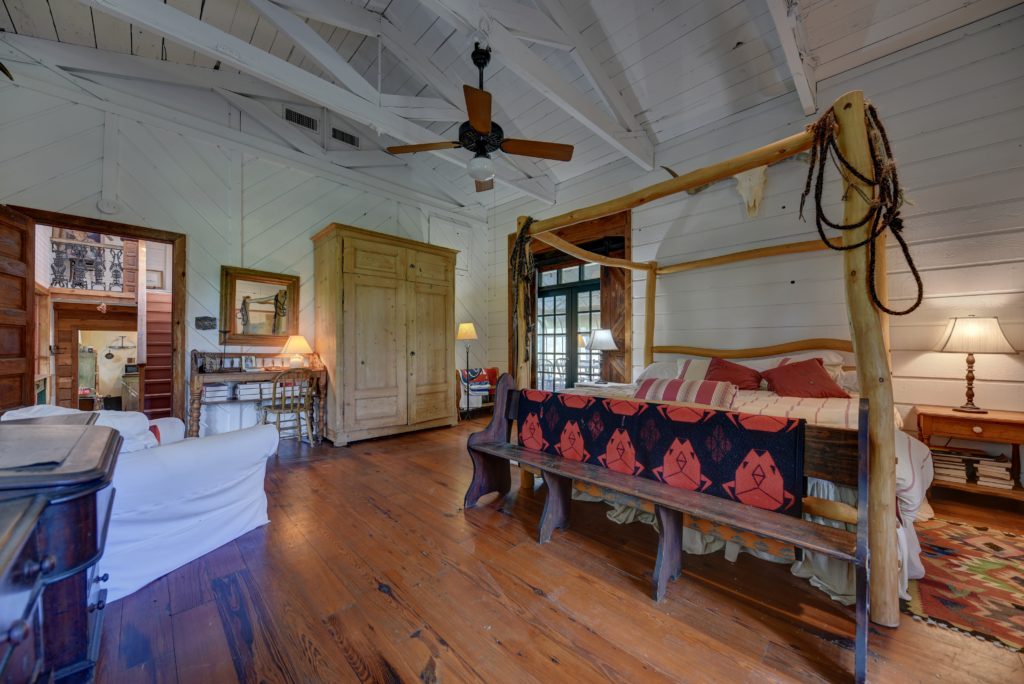 High ceilings and open truss work provide character to the master bedroom. (Photo by John Deans, Deans Imaging)