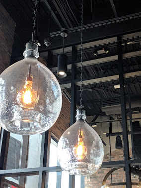 The glass lanterns above the bar are hand-blown. (Photography by Tina Zulu)