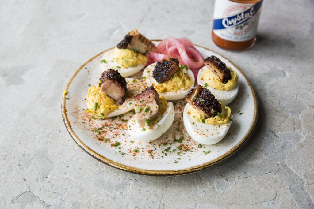 Deviled eggs with smoked pork belly and pickled onions is a favorite. 