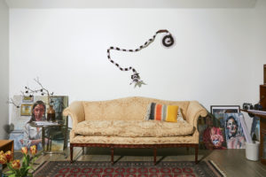 Works in progress by Havana-born de las Cuevas lean against the rear wall of the studio/sitting room. The brocade-covered camelback sofa belonged to Koush’s maternal grandmother. Taxidermy squirrel sporting a crochet bodysuit is by Houston artist Elaine Bradford. (Photo by Pär Bengtsson)