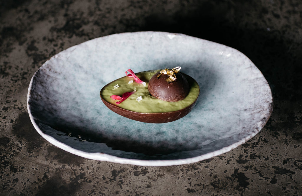 Each course is plated on custom ceramic dishes, and the food is meant to provoke conversation. (Photo by Caroline Fontenot)