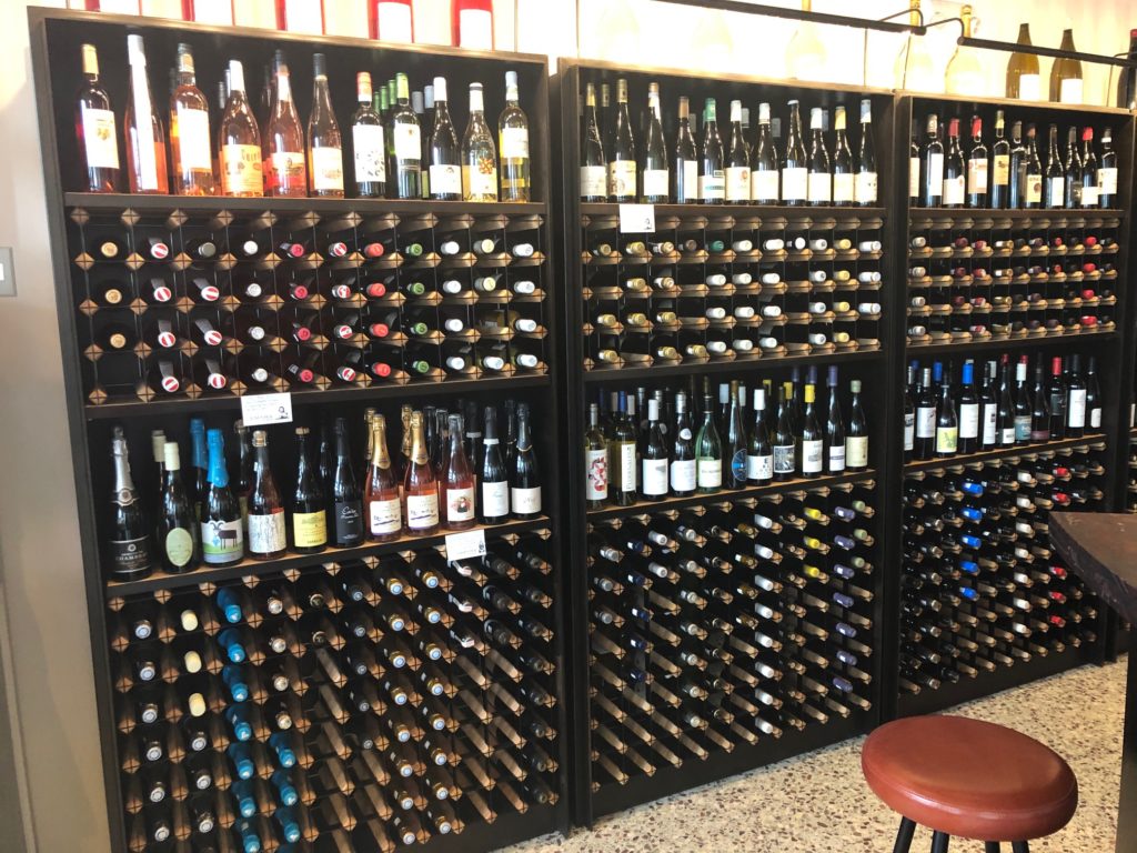 The shelves are filled with more than 150 wines carefully selected by wine director Ryan Cooper. (Photo by Shelby Hodge)