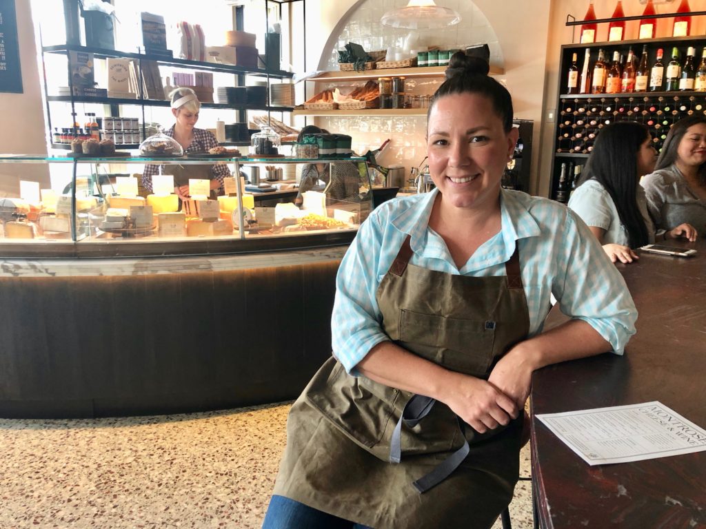 Montrose Cheese & Wine GM and cheesemonger Shannon McCracken oversees the seasonally-changing selection of a dozen or more cheeses. (Photo by Shelby Hodge)