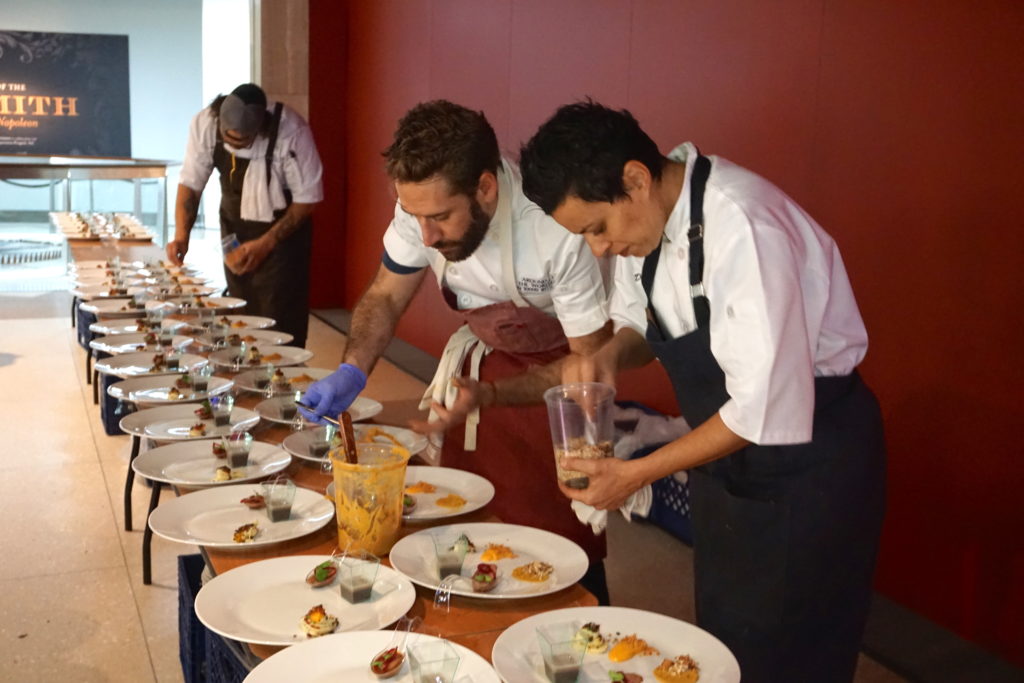 Chefs Javier Becerra and Debora Teixeria working on plates for the 120 guests.