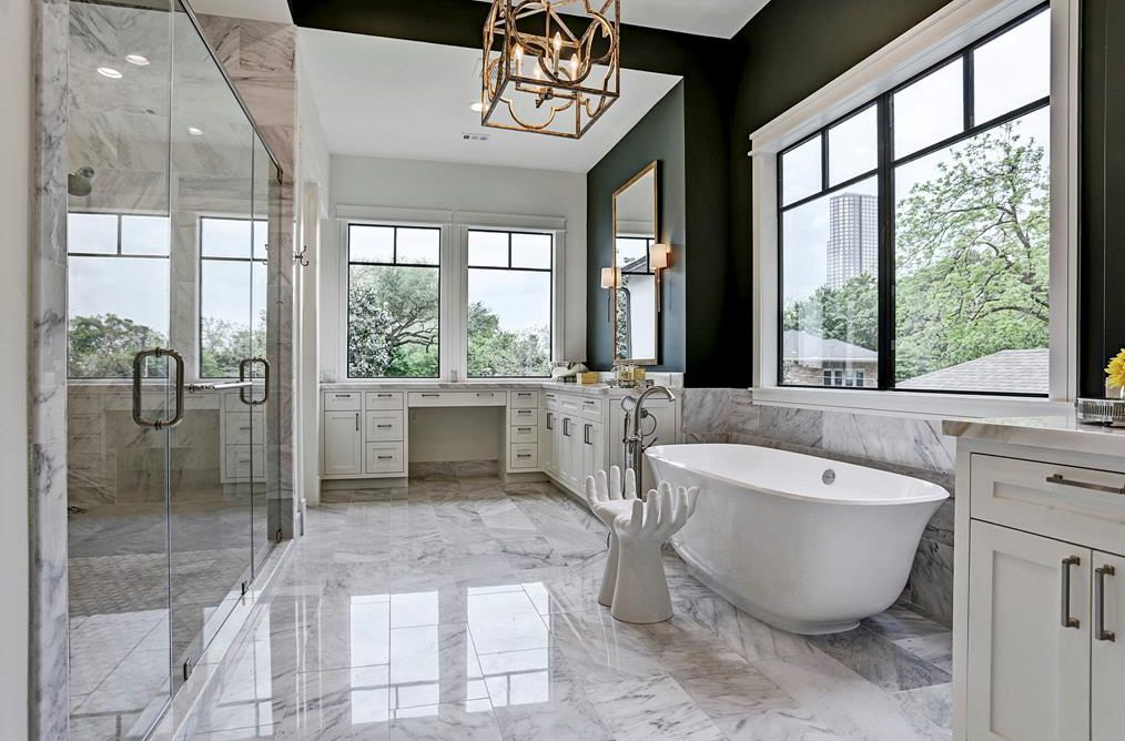 The free-standing tub and chandelier are popular elements in the modern master bath as seen in this house by Masa Studio Architects and Smith Family Homes. 