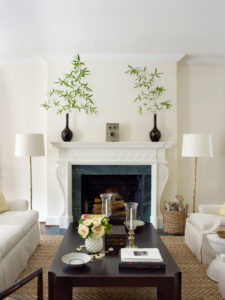 A fireplace surround in plaster at a Dallas Highland Park home designed by Tom Scheerer. On mantel, Han dynasty brazier references Rome’s famous Bocca della Verita. Coffee table is vintage Michael Taylor, painted. (Photo by Francesco Lagnese)