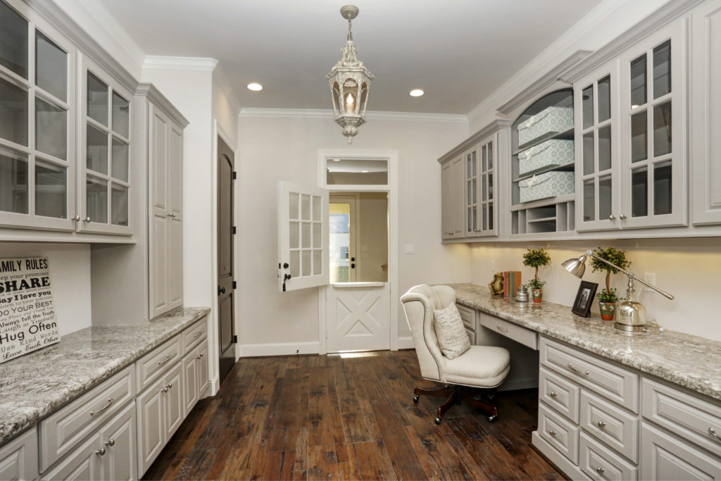 A familiar take on the all-so-necessary home office with ample storage and built-ins, this design is often located next to the kitchen. 