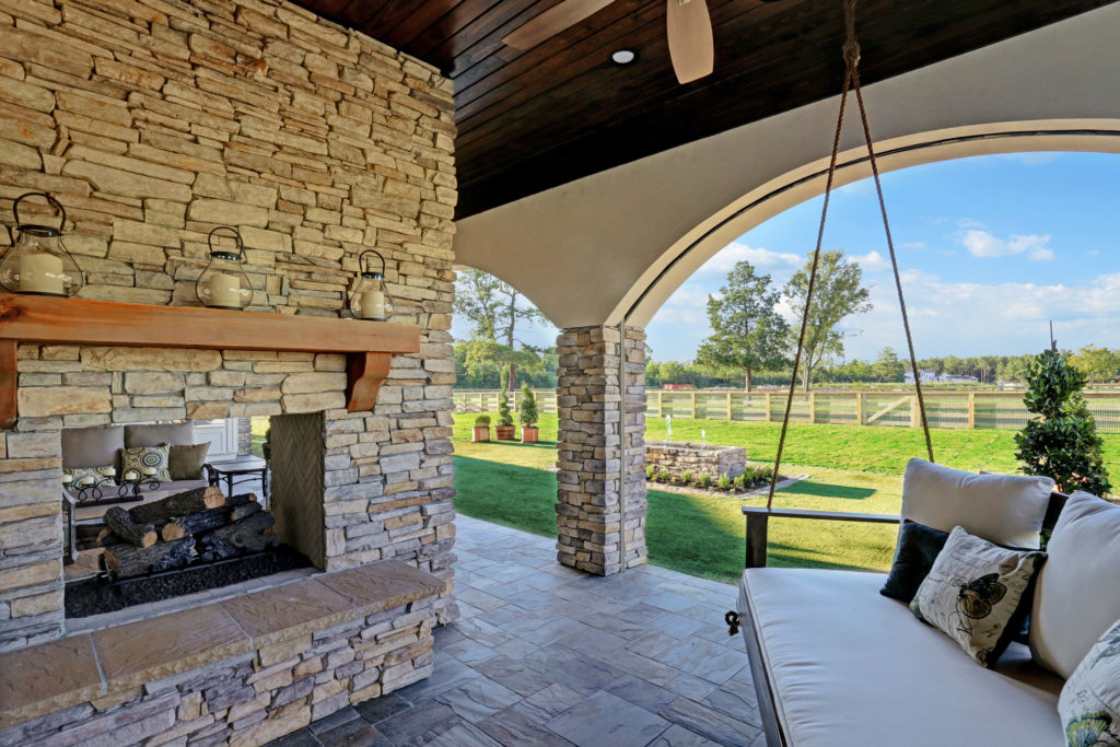 The back terrace is complete with double-sided fireplace and ceiling fans.