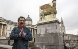 Michael Rakowitz stands with his work in London’s Trafalgar Square, 2018, “The Invisible Enemy Should Not Exist.” The human-headed figure of a winged bull (lamassu) is constructed from cans of Iraqi date-syrup, a staple of the region’s cuisine. (Photo Rick Findler/PA Wire, courtesy Jewish News Times of Israel)