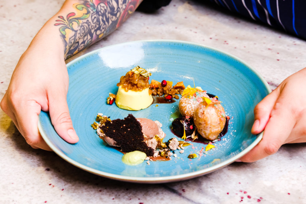 A trio of desserts including the flan, donut, and chocolate ice cream. 