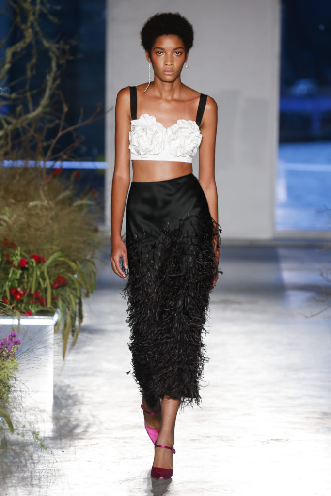 Jason Wu black feathered mid-calf-length skirt, white bralette with contrasting black stripes. (Photo courtesy of Jason Wu)