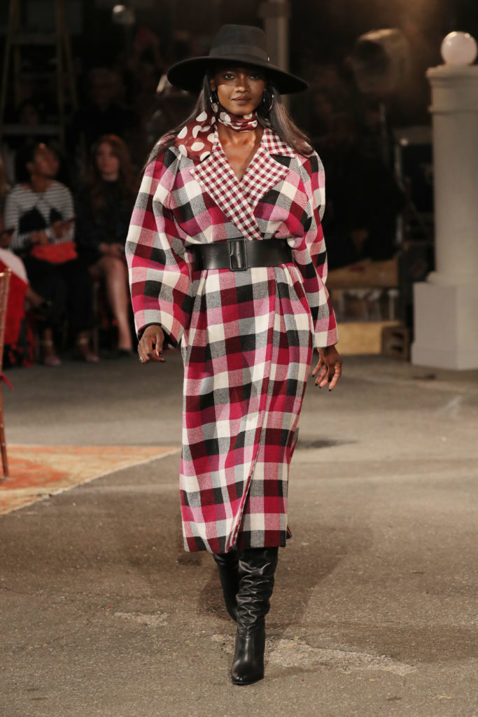 Tommy X Zendaya check coat, leather belt, polka dot neck tie, leather boots. (Photo courtesy of Tommy Hilfiger)