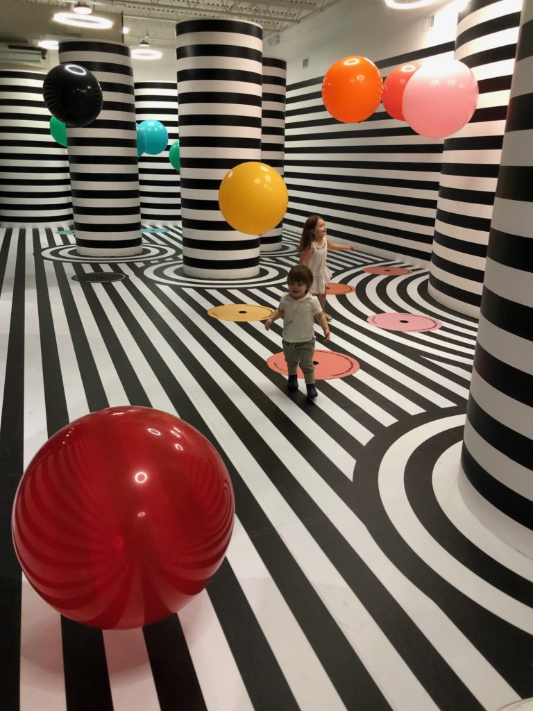 The Color Factory's "Thought Bubbles” is  black-and-white striped space populated with colorful floating balls that float up and down with blasts of high flow, low-pressure air. (Photo by Clifford Pugh)