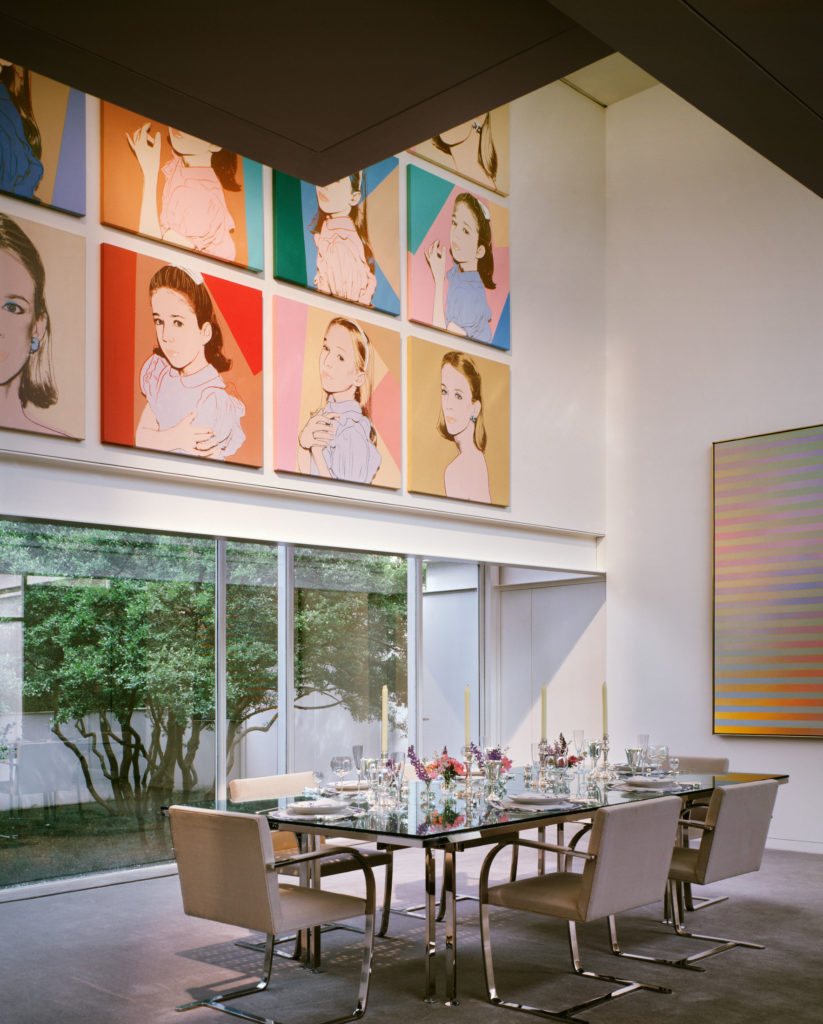 In the Bass house, 1970, Paul Rudolph designed the table, surfaced with subway grating and inset with mirrors. Bass family portraits by Andy Warhol.