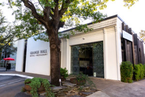 The white facade to Grange Hall which belies the dark and moody space found within.