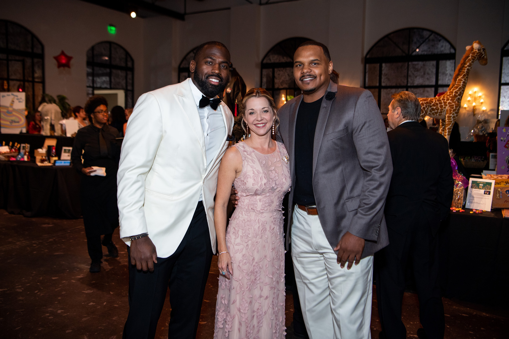 Whitney Mercilus, Julie Finck, Chester Pitts at Barbara Bush Houston Literacy Foundation Jungle Book Gala