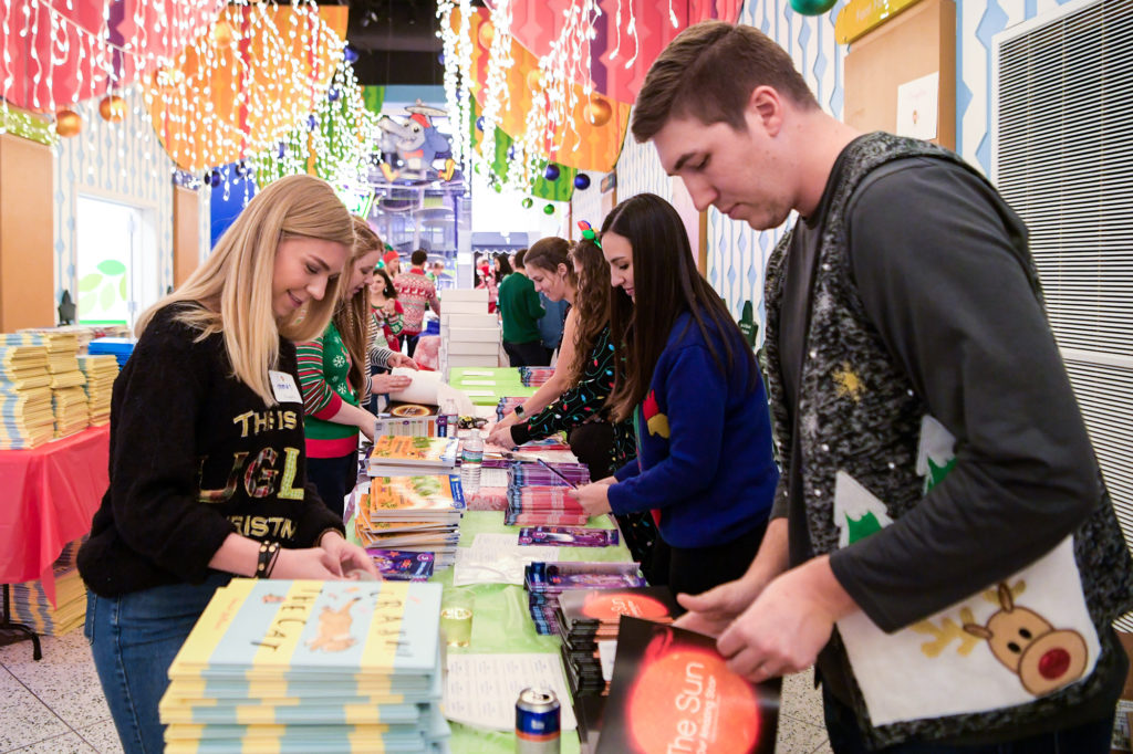 Young professionals pack books for the foundation's My Home Library program. (Photo by Michelle Watson/CatchlightGroup.com)
