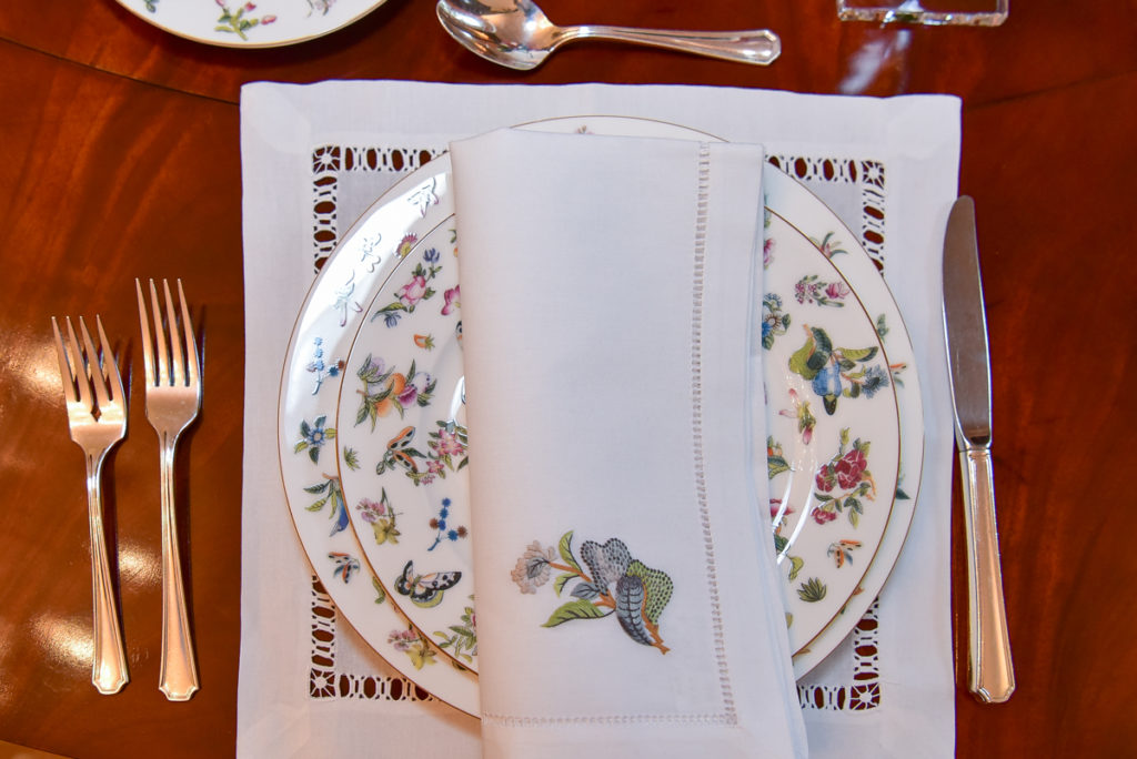 The linens, matching the porcelain patterns, are hand-embroidered in Vietnam.