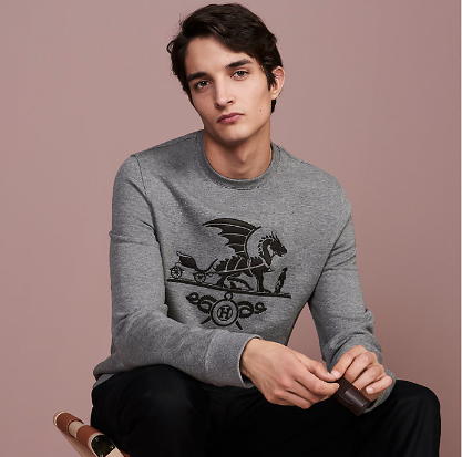 "Ex-Libris Dragon" crewneck sweater with leather patch detail from Hermès is perfect for under the tree. Available at Hermes.com and select Hermès stores.