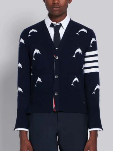 Thom Browne’s navy cashmere dolphin intarsia v-neck 4-bar cardigan available at Thombrowne.com or select stores.