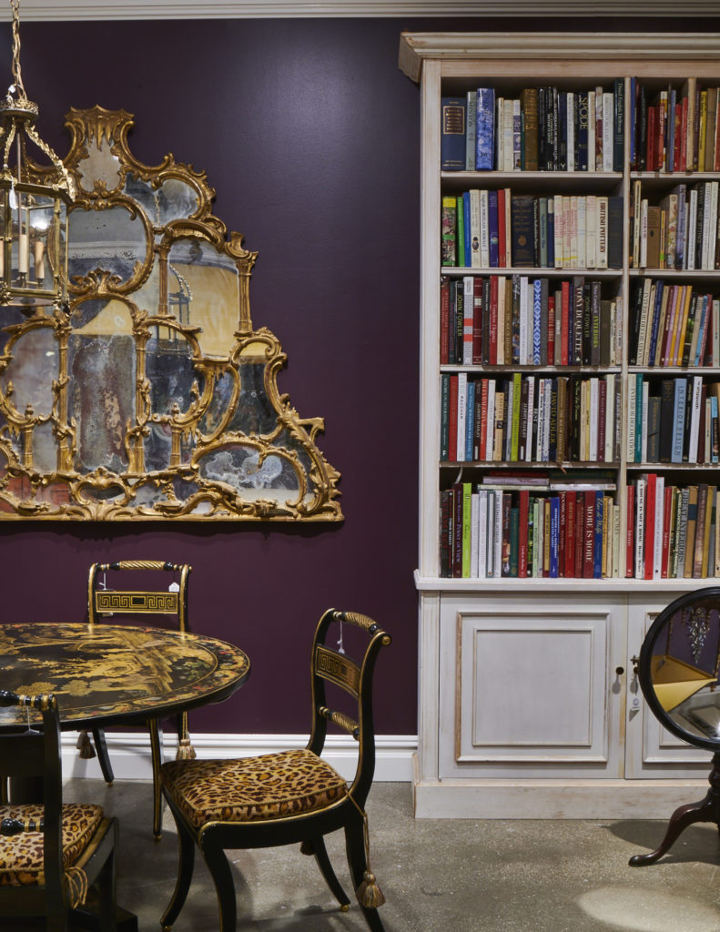 A gilt mirror and a sampling of Buatta's library. (Photo by Gabby Jones)