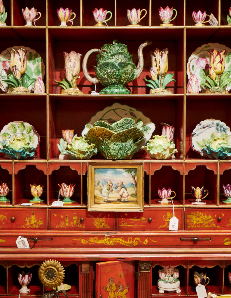 A George III Red Japanned Bureau cabinet containing cabbage tureens and English porcelain tulip cups. (Photo by Gabby Jones)