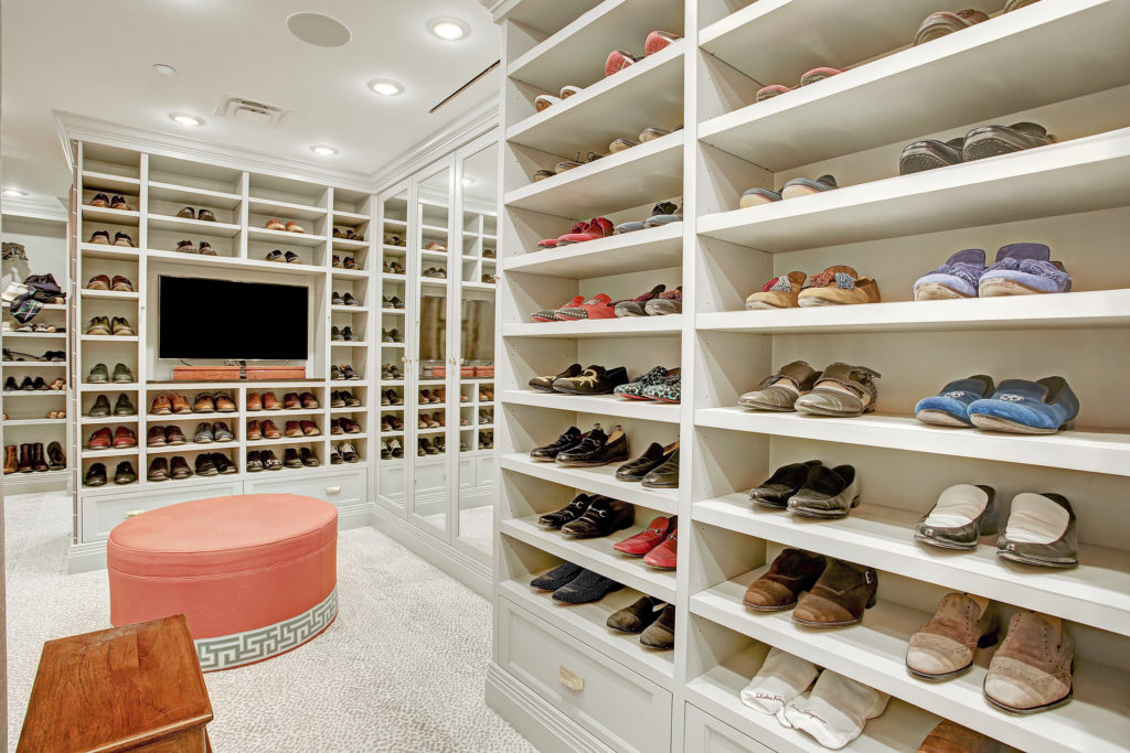 No. 32 in Villa d'Este in Uptown Park features a pristine closet where John Lobb shoes are on display. Note the television. Compass agent Laura Sweeney has the listing.