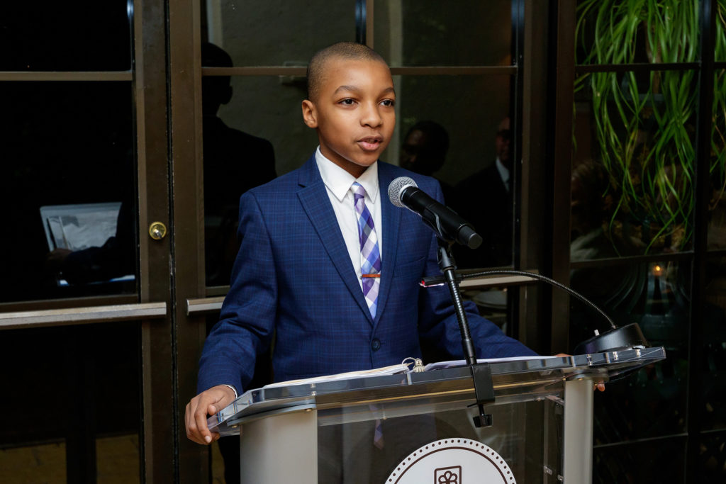 Colin Harris speaking at the podium about Dr. King's vision for America in 2020. (Photo by WJN Photo)