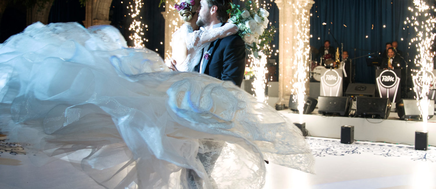 Mr. and Mrs. Carlos Gómez del Campo Neme celebrating at their wedding reception in Mexico City's Colegio de San Ignacio de Loyola Vizcaínas.