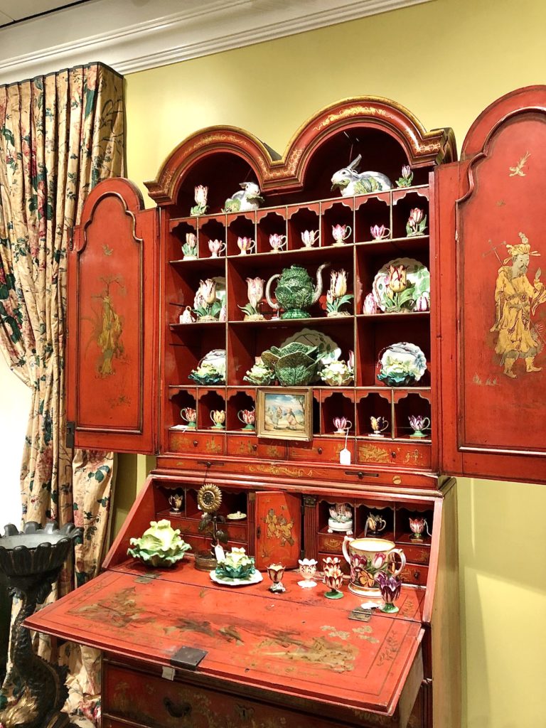 A George III Red Japanned Bureau cabinet containing cabbage tureens and English porcelain tulip cups. (Photo by Lacelliese King)