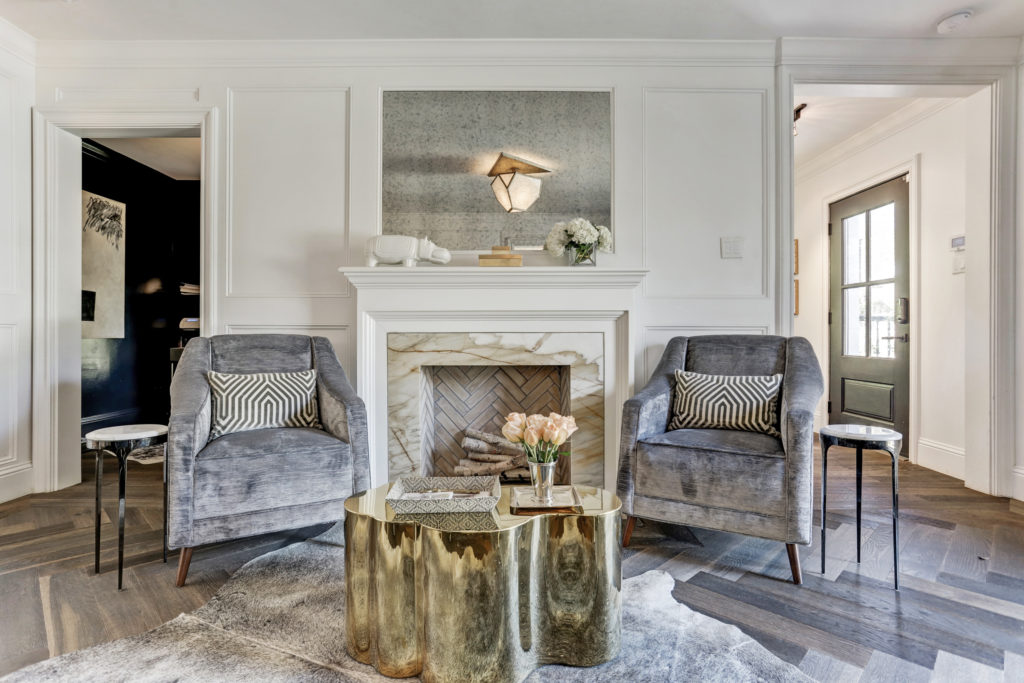 The color palette and mix of classic and contemporary furnishings make this house sing. The curving brass table is custom. (Photo by TK Images)