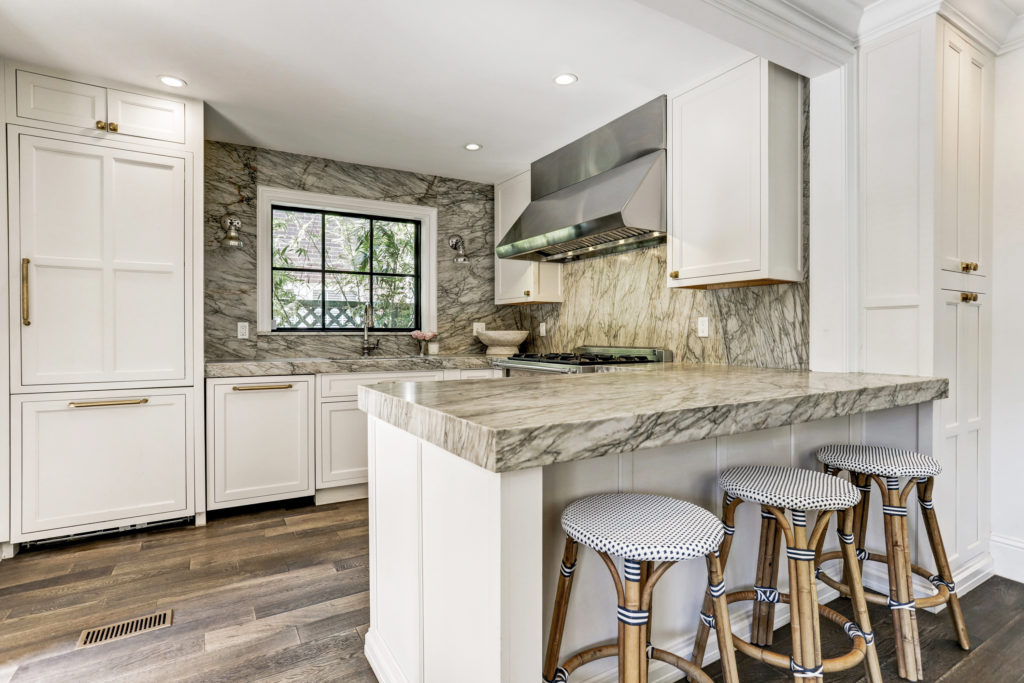 The kitchen features custom cabinetry and hardware. (Photo by TK Images)