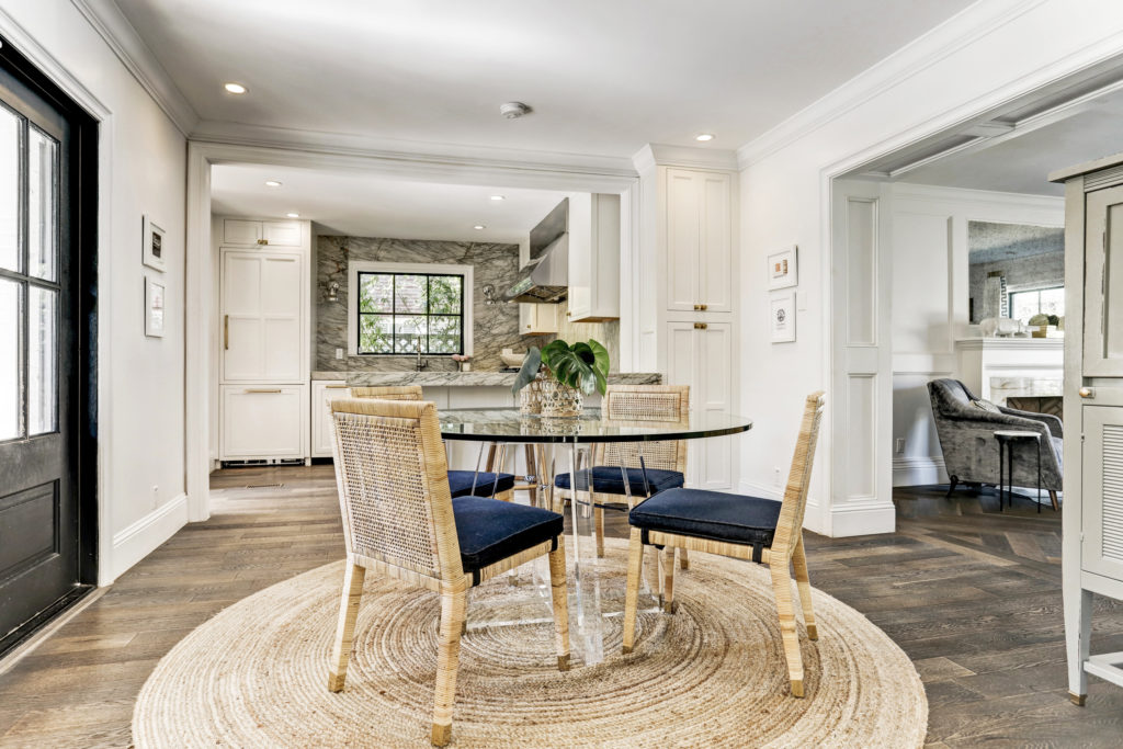 The sleek breakfast room features a table from Interlude Home surrounded by chairs from Serena & Lily. (Photo by TK Images)