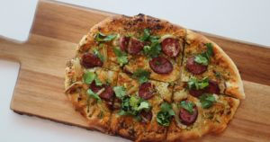 atico – coca flatbread with deer salami, roasted fennel, manchego cheese, and roasted jalapeño pesto.