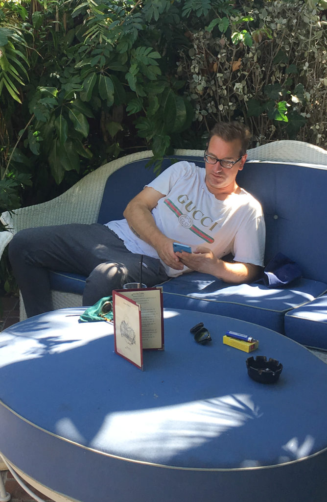 Michael Bevilacqua lounging by the pool while we wait on the room.