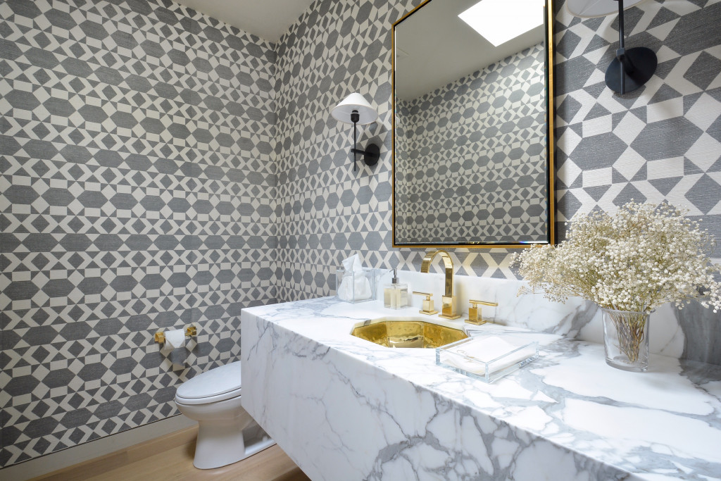 Phillip Jeffries patterned grasscloth covers walls of the guest bath that features Statuario white marble.