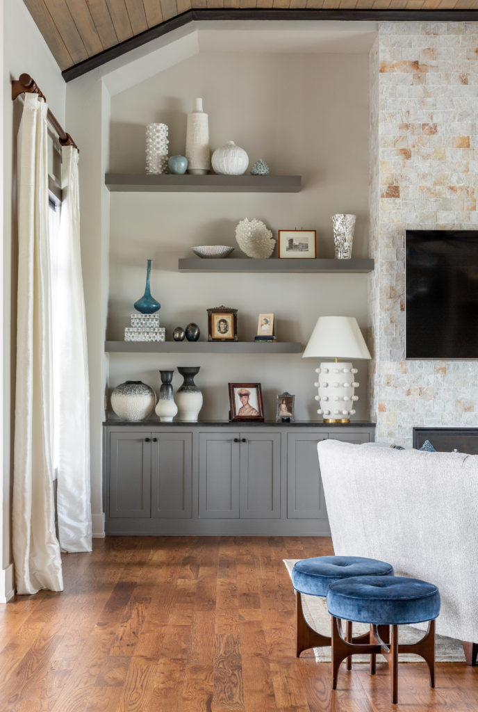 Collectibles line the shelves adjacent to the fireplace. (Photo by Jen Burner)