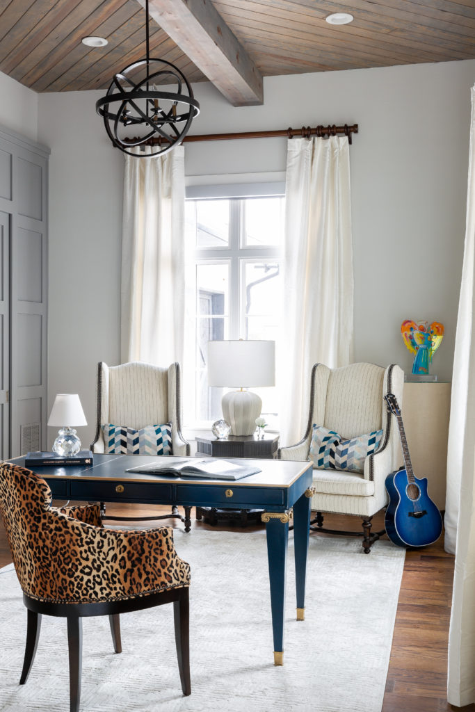 The man of the house is a rock 'n roll fan so the designers brought in a bit of attitude wiht the blue leather-wrapped desk from Theodore Alexander and a leopard print chair from Century. (Photo by Jen Burner)
