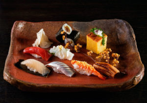 A selection of edomae sushi at Tei-An in Dallas. Top row, kanpyu maki (salted gourd roll) and tamago (sweet omelet). Second row, zuke maguro (tuna) and yari ika (squid). Bottom row, hirame kobujime (flounder), kohada, kuruma ebi (shrimp), and anago (sea eel). (Photo by Kevin Marple)